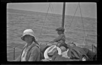 Elizabeth West and Wilfrid Cline ride aboard a bait boat, Hermosa Beach, about 1920