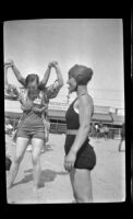 Grace Liggitt stands on the beach, Hermosa Beach, about 1932