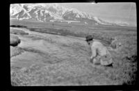 Charlie Stavnow fishes in Convict Creek, Mammoth Lakes vicinity, about 1920