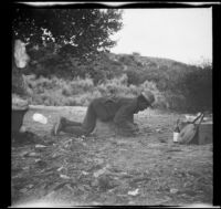 Charles Davis of Indianapolis lies on top of a wooden box, Acton, about 1906