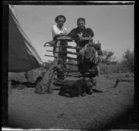 Joe Pike and Kelly Reese pose by a gun rack, San Diego County, about 1908