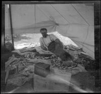 Joe Pike reclines in a tent, San Diego County, about 1908