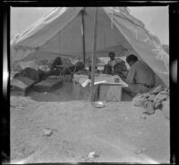 Joe Pike and Dick Young rest inside their tent, San Diego County, about 1908