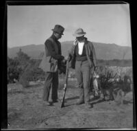 Webster and Bob Brain stand with a gun, Irwindale, about 1900