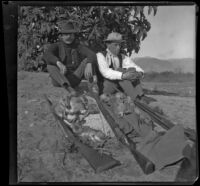 Webster Brain and Bob Brain sit under a castor bean plant, Irwindale, about 1900