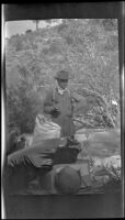 George Saum stands in the campsite, Olancha vicinity, about 1920