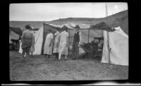 Members of the Witherby, Whitaker, Shaw and West camping party stand around their campsite at Abalone Point, Laguna Beach, 1924