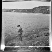 Glen Velzy fishes from the rocks, Laguna Beach, 1914
