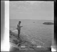 Glen Velzy fishing from the rocks, Laguna Beach, 1914