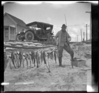 H. H. West poses with fish, Newport Beach, 1914