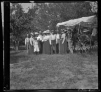 H. H. West stands with a group in front of a wagon, Elliott vicinity, 1900