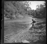 Independence (Inda) Stevens fishes in the Nishnabotna River, Elliott vicinity, 1900