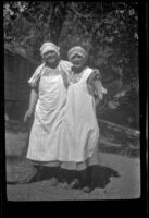 Nina Meyers and Mertie West pose while wearing aprons, Ojai vicinity, about 1925