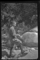 H. H. West, Jr. fishes from rocks in Matilija Creek, Ojai vicinity, about 1925