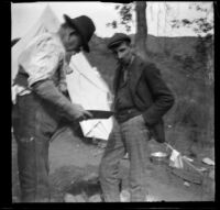 George M. West and Frank Lemberger check their pan for gold, Monrovia, 1898