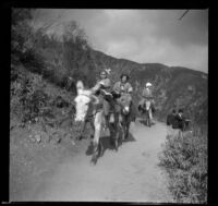 Frances West and Mary West riding donkeys along a mountain trail, Mount Wilson, about 1909