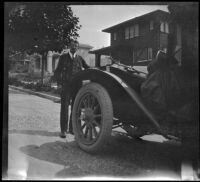 Frank Lemberger posing in front of his house and H. H. West's Buick, Oakland, about 1915