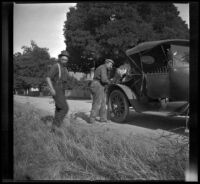 Glen Velzy walking over to help Al Schmitz fix a flat tire, Mendocino County vicinity, 1915