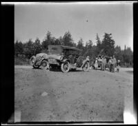 Members of the West, Velzy and Schmitz traveling party standing and posing near the Velzy's Buick, Mendocino County vicinity, 1915