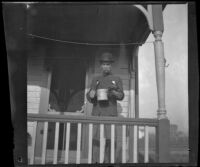 John L. Lemberger stands on the porch of his house, Ottumwa, 1900
