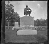H. H. West perches on top of a headstone, Ottumwa, 1900