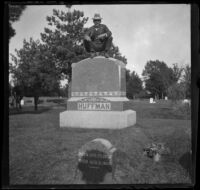 H. H. West perches on top of a headstone, Ottumwa, 1900