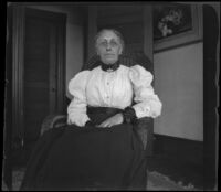 Kate Mertz sitting in a chair at home, Palo Alto, 1898