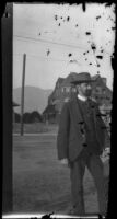 Man with a beard standing by a street, Pasadena, 1899