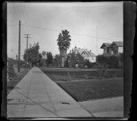 Residential street in Pasadena, viewed from the sidewalk, Pasadena, 1899