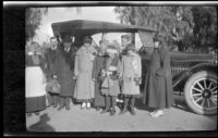 Caroline Lemberger, Wayne West, Wilson West, Mary West, Wilhelmina West, Frances West, Maud West, Elizabeth West, and Nella West pose in front of a car, Redlands, about 1916