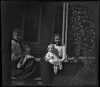 Grace Butterfield and Claude Bishop sit on a porch holding children on their laps, Red Oak, 1900