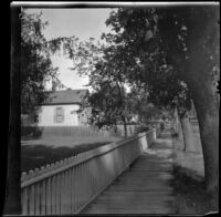 Wooden sidewalk in front of the former home of the West family, Red Oak, 1900