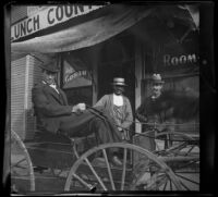 Carl Austin sits in a buggy while Will Longstreet and Sam Longstreet stand next to it, Red Oak, 1900