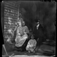 Carl Austin sits on a porch with his mother and daughters, Red Oak, 1900