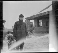 Doc Will Reilley standing in the snow outside the train depot, Red Oak, 1917
