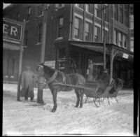 Sleigh traveling down a snow-covered street, Burlington, 1917
