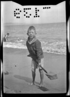 H. H. West, Jr. shoveling sand at Rincon Point, Carpinteria vicinity, about 1924