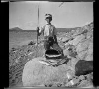 H. H. West Jr. poses with trout that he caught in Grant Lake, Mono County vicinity, 1929