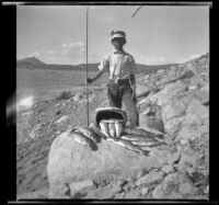H. H. West Jr. poses with fish caught in Grant Lake, Mono County vicinity, 1929