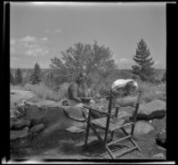 Josie Shaw sits on a rock and reads, Mono County, 1941