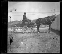 Man sits in a horse-drawn cart, San Francisco, 1900