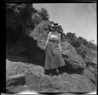Mertie Whitaker posing in front of a boulder at Mount Tamalpais, Marin County, about 1900