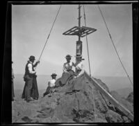 Nella West and Mertie Whitaker sitting at the base of a signal tower on Mount Tamalpais, Marin County, about 1900