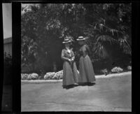 Mertie Whitaker [West] and Nella West posing in a park, San Jose, about 1900