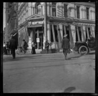 Street corner with soldier standing guard, Oakland, 1906