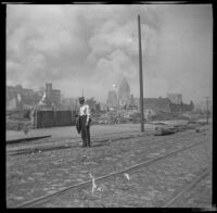 Franz Nelson stands in front of a block destroyed by the San Francisco Earthquake and Fire, San Francisco, 1906