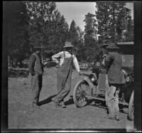 Adolph Bystle, John Bidwell, and another man stand by a car, Shasta County vicinity, 1915