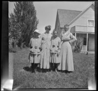 Frances, Mary, and Elizabeth West pose with Amanda Bidwell in the front yard of a house, Shasta County vicinity, 1915