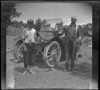 Wilfrid Cline, Jr. and Harry Schmitz posing with trout caught from Cow Creek, Redding vicinity, 1917