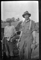 Wilfrid Cline, Jr. and Harry Schmitz posing with doves shot near Cow Creek, Redding vicinity, 1917